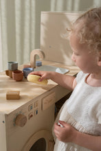 Load image into Gallery viewer, Child playing with a wooden dishwasher kitchen set in a room with light-colored walls.
